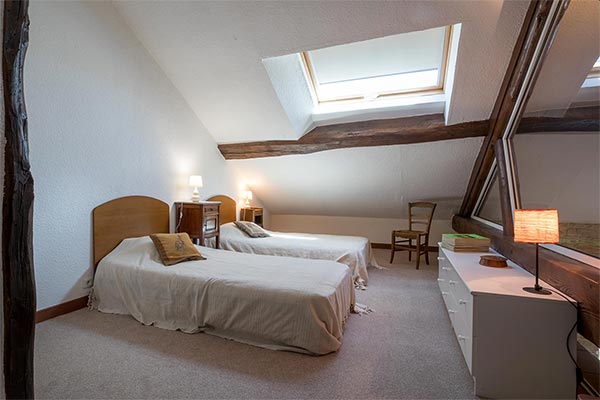 The mezzanine bedroom is set under the eaves